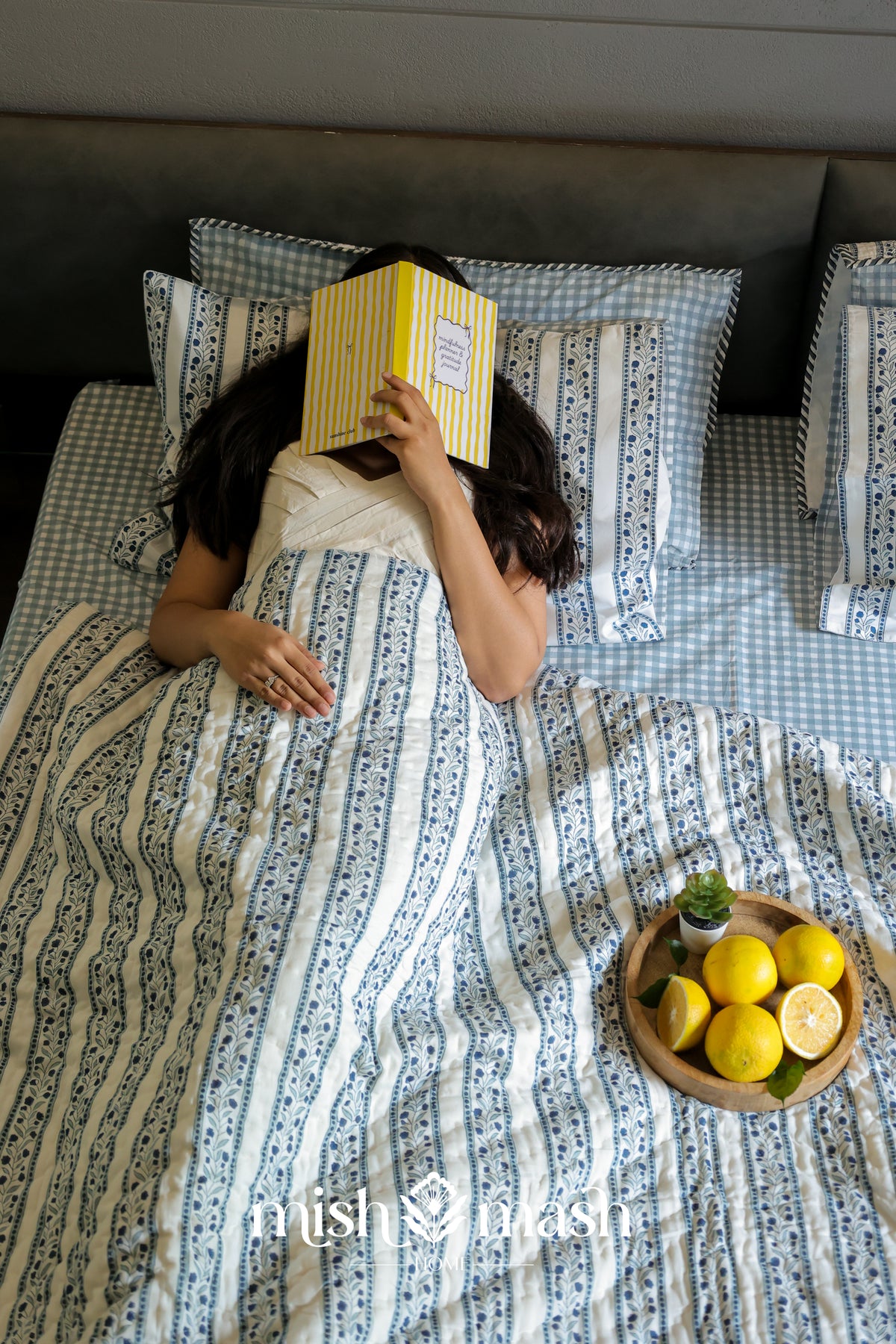 ac quilt with a woman lying on cotton bed sheet