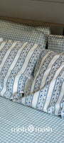 gingham blue bed sheet with floral pillow covers