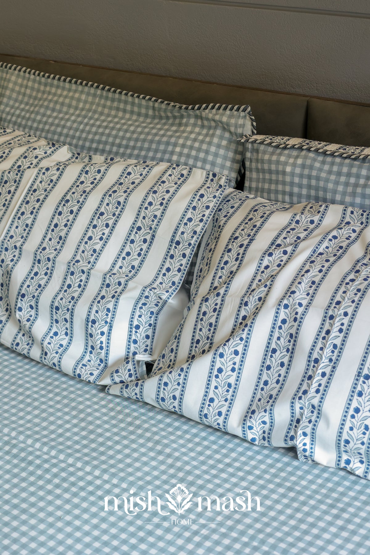gingham blue bed sheet with floral pillow covers