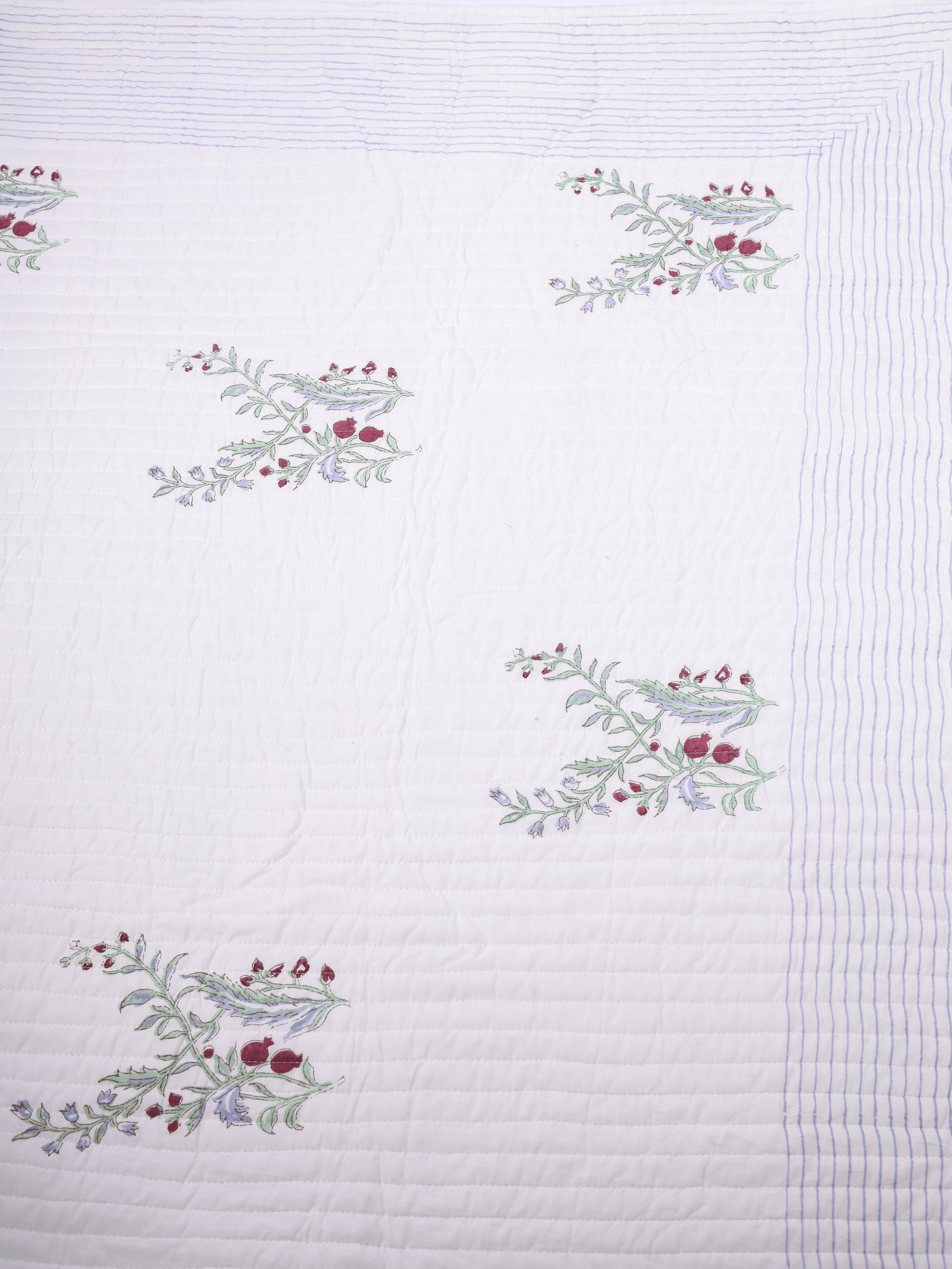 Reversible bed cover with green stripes and anar print