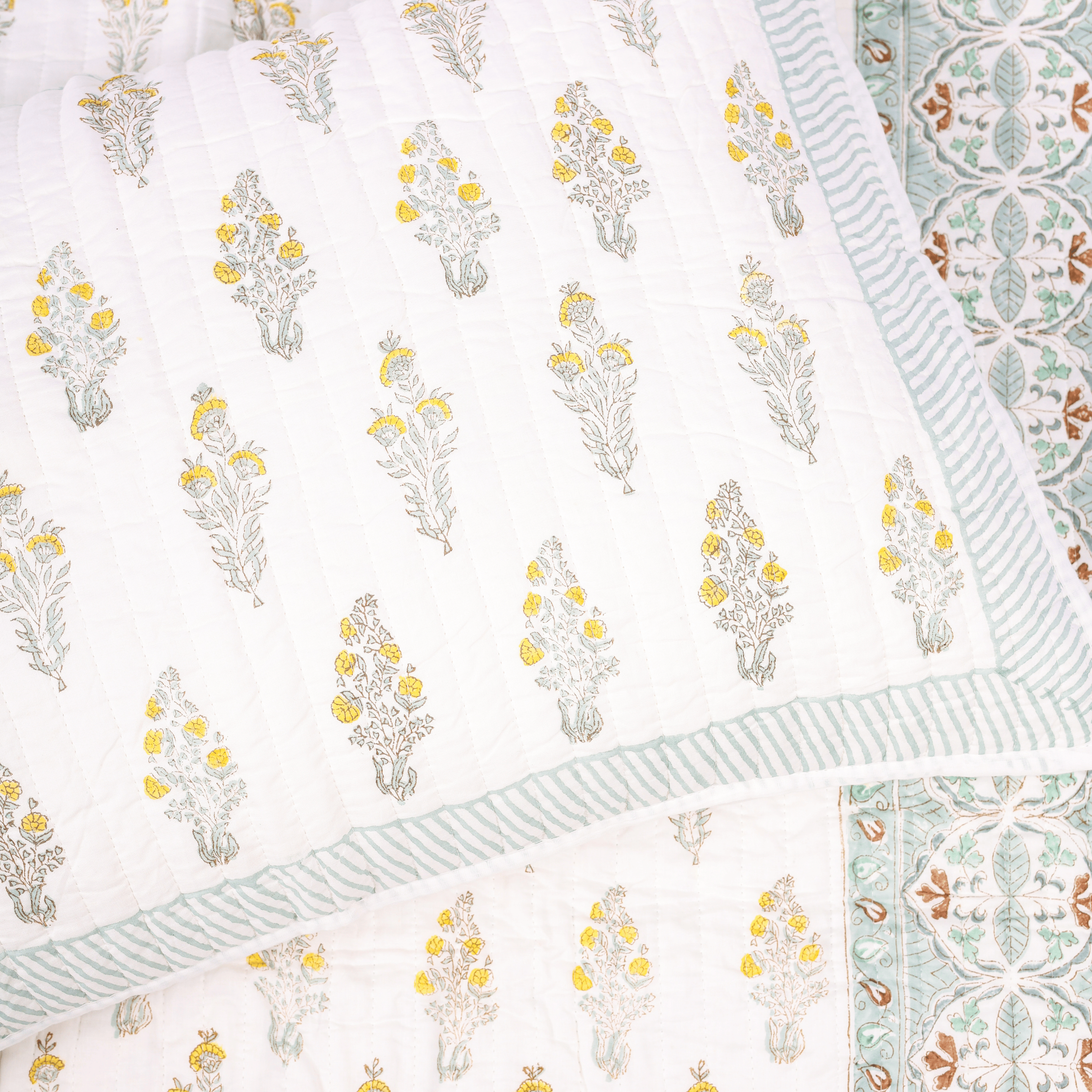 Reversible double bed cover with floral and chevron design