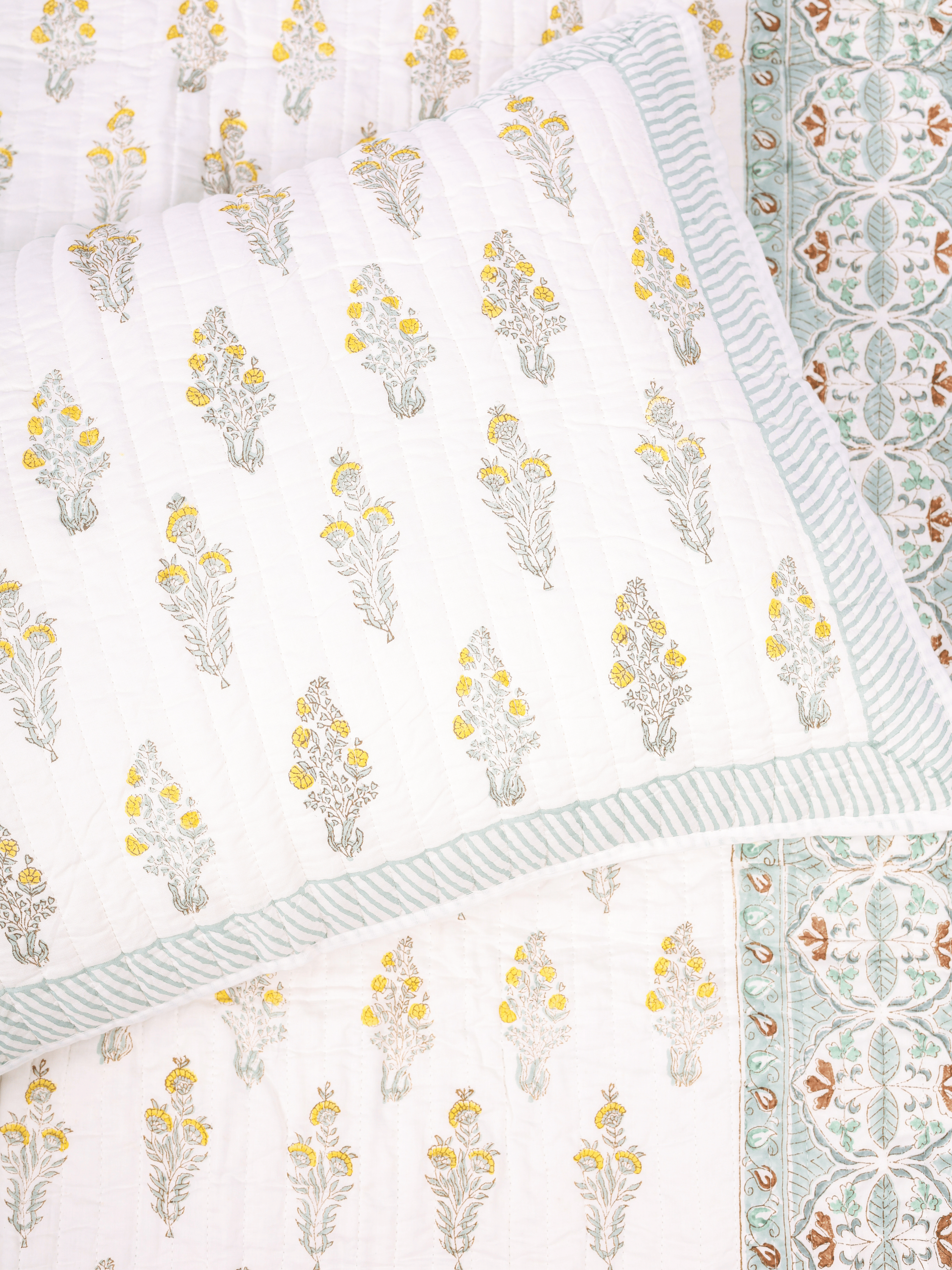 Reversible double bed cover with floral and chevron design