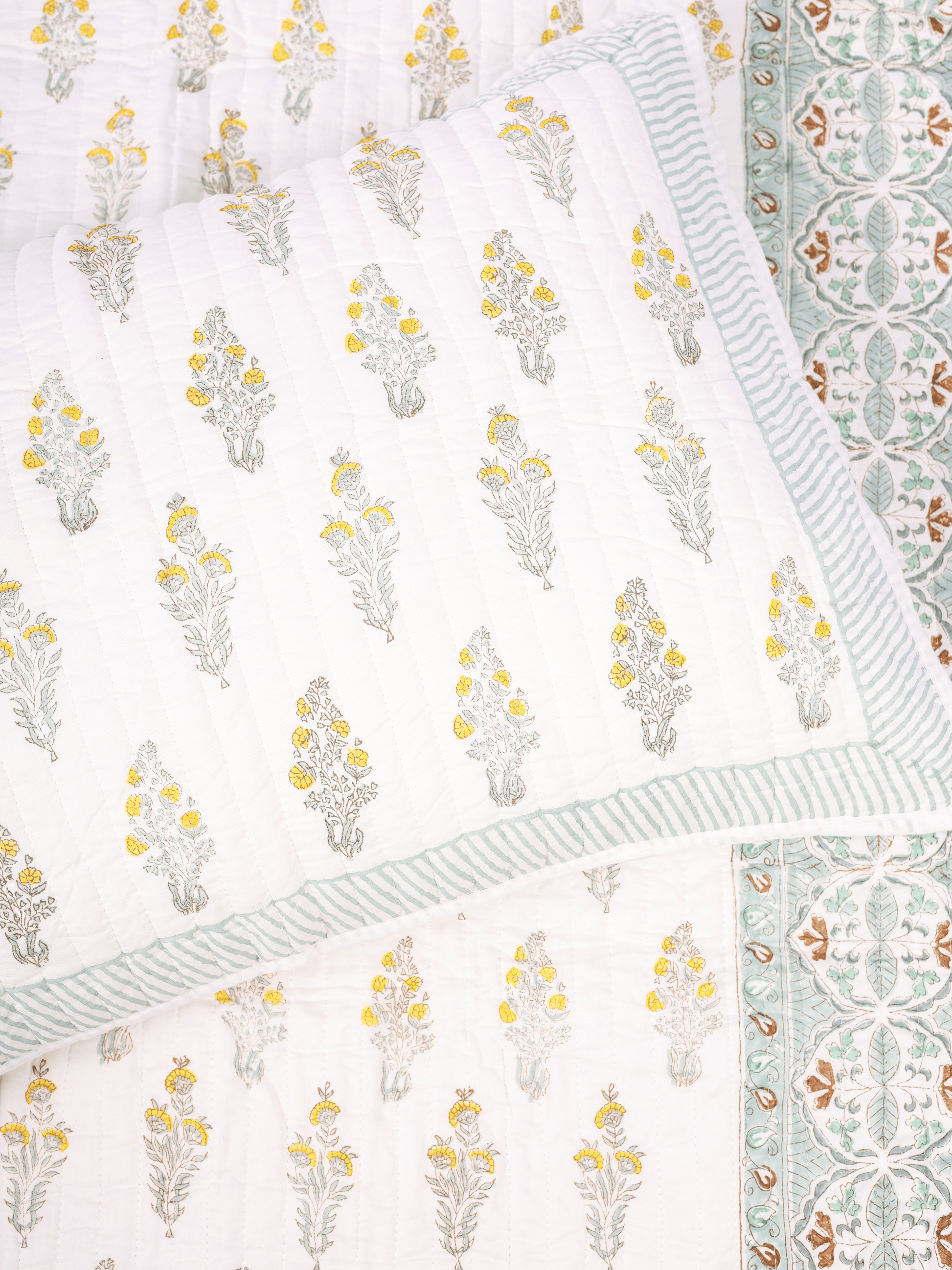 Reversible double bed cover with floral and chevron design