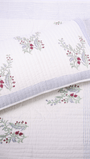 Handcrafted white bed cover with red and green pomegranate print